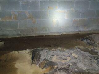 Obvious signs of moisture issues are present; you can clearly see water is pooling up by the foundation wall. The encapsulation treatment will totally separate and protect the crawl space interior from outdoor conditions, keeping the space clean and dry.