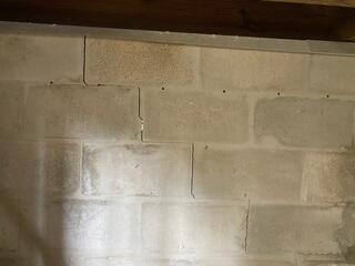 Severe foundation settlement had caused wide cracks between the home's brick walls-so large that daylight could be seen straight through them.