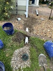 This Jacksonville home was experiencing water pooling near the foundation due to improper runoff from the downspouts. Standing water like this can cause soil erosion and put stress on the foundation. To begin solving the issue, our team installed an underground drainage line with a catch basin. This setup allows water to flow away from the house instead of soaking into the soil near the structure, protecting the home from future water damage.