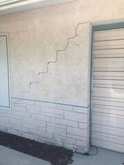 Large stair-step cracks formed in the home's walls, a clear sign of foundation settlement.
