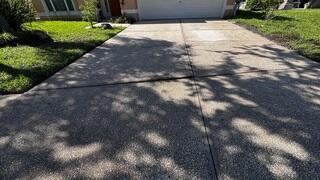 Soil settlement beneath the homeowner's concrete driveway caused the slabs to become uneven and led to cracks forming along the surface.
