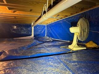 This DIY vapor barrier was not working. The crawl space was constantly getting wet and the homeowner was over it.