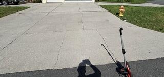 The homeowner's concrete driveway had suffered significant damage, with multiple cracks and sinking slabs caused by soil settlement and the removal of nearby tree roots.