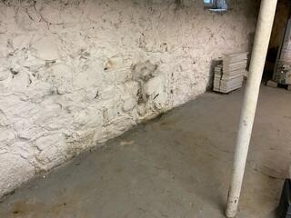 During periods of heavy rainfall and snowmelt, water infiltrated the basement through cracks in the fieldstone foundation walls, compromising the space and making it unsuitable for storing personal belongings. Seeking to reclaim and utilize the basement safely, the homeowner pursued a comprehensive waterproofing solution designed to address moisture management.