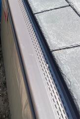 A top-down view of the new Musket Brown Gutter Shutter system installed on Jeremy's garage addition in Sharon, MA. The gutters sit neatly along the roofline, blending in with the home while providing strong, clog-free protection