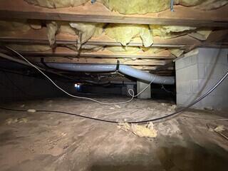 Before encapsulation, the crawlspace only had a thin liner laid on the ground.