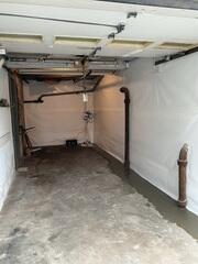 This below-grade garage and basement space was transformed by our waterproofing system to ensure it is no longer a problem.