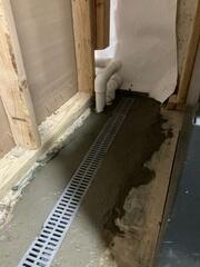 TrenchDrain was installed near the entrance of the basement to stop outside water in its tracks, preventing it from spreading into the rest of the space.