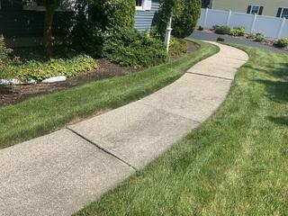 Voids beneath the concrete walkway led to differential settlement of the slabs, resulting in misalignment and an unsightly appearance that detracted from the home's curb appeal