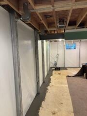 These steel beams along the wall will make sure the walls won't cave in any longer. They can also be adjusted over time to attempt to straighten the walls back out. We adjust them through their top bracket, which is connected to the floor joist system.