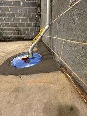 SuperSump is installed to take on the heavy water leakage in the basement and pump it out far from the home's foundation.