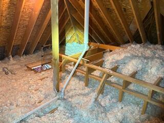 This degraded blown-in fiberglass did not provide enough R-Value to block drafts effectively.