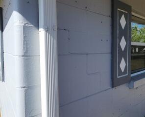 Stair-step pattern cracks had appeared in the walls of the homeowner's garage, a common sign that the foundation had settled.
