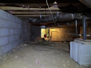 This Pittsboro, NC crawl space showed clear signs of structural instability, including improper support methods and unleveled ground conditions. Temporary materials, such as stacked cinder blocks, were being used in place of a professional foundation support system, which can lead to sagging floors, shifting beams, and long-term structural damage. The condition of this space highlighted the need for a reliable stabilization system and moisture control solutions to restore safety and protect the home's integrity.