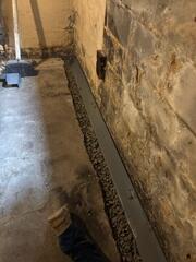 WaterGuard was installed around the perimeter of the basement to collect any water seepage from the walls to direct to the sump pump for removal.