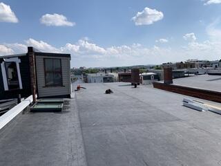 The finished EPDM roof provides a smooth, watertight surface built to handle all weather conditions. With the addition of new Velux skylights, this building is now both protected and brightened for years to come.