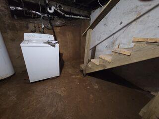 This Greensboro, NC basement showed clear signs of moisture buildup and water intrusion before waterproofing. The dark stains and damp surfaces on the walls and floor reveal where water frequently pooled after rain. The unprotected concrete and wooden structures were vulnerable to humidity, leading to musty odors and potential mold growth. This image marks the starting point of the transformation where our team would later install a full waterproofing system to create a dry, clean, and protected space.