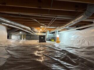 Our CleanSpace liner completely seals off the crawl space from the earth, creating a bright, clean, and dry environment. Our SaniDry Sedona dehumdiifier sits in the middle of the crawl space.