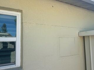 Horizontal and stair-step cracks along the exterior walls of the home were a clear sign that the foundation was settling.
