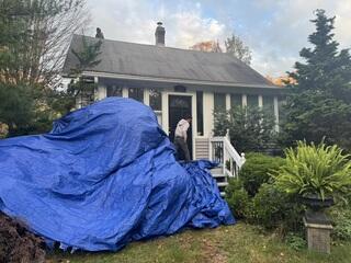 Before the teardown begins, the crew lays out large tarps to fully protect the homeowner's property and make cleanup efficient by catching all the falling debris.