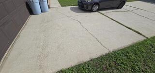 Soil settlement beneath the homeowner's driveway had caused the concrete to sink and crack.