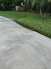 Soil erosion beneath the homeowner's driveway had caused the concrete slabs to settle and crack.