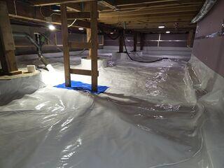 Our bright white liner is permanently sealed to the walls, footing, and side of this crawl space.