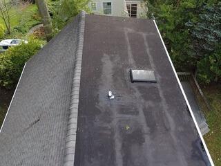 Here's what the old low-sloping roof section looked like on Sally's home. It was showing signs of age and wear. Swipe through to see the incredible transformation!