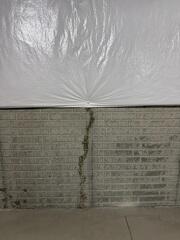 This leaky crack was causing not only water stains but high humidity in the basement.