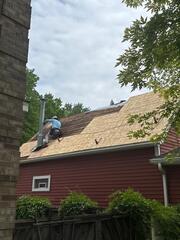 Old shingles being removed and replacing the damaged decking