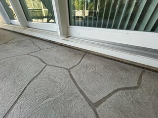 The back patio's original channel drain had worn out over time, struggling to handle flowing rainwater and frequently causing backups.