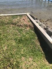 Over time, soil erosion had created voids behind the homeowner's seawall, compromising its stability and support.