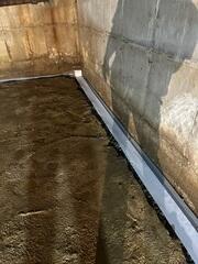 WaterGuard was installed around the perimeter of the basement to collect any seeping water from the walls and floors and direct it to the sump pump for removal.
