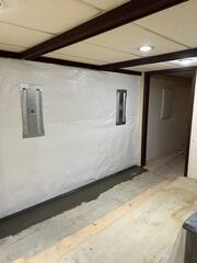 Each anchor assembly consists of a 12" x 28" interior wall support plate and a 16" x 26" exterior anchor plate below grade.