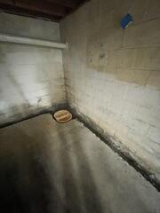 An area is excavated at the lowest point in the basement to place the container for the sump pump system.