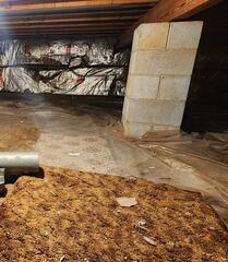 The crew arrived on the job to find that the crawl space had been lined with a thin plastic liner that was torn and allowing water to enter. The insulation was also showing signs of wear and moisture damage.
