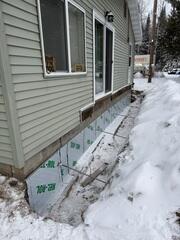 Exterior trench excavated to access stable soil for the earth anchors. This step ensures the GeoLock® system can counteract soil pressure and support long-term wall stability.