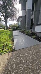 Soil erosion beneath the homeowner's concrete walkway had caused the slabs to settle, creating a significant tripping hazard.