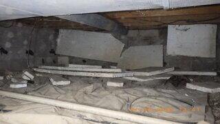 This crawl space is saturated with moisture and cluttered with debris, creating conditions that encourage mold growth, structural damage, and poor indoor air quality-making cleanup and encapsulation essential.
