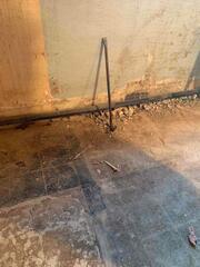 The basement walls had a 'waterproof' paint on them, which had bubbled, cracked, and was letting water through