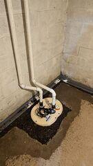 A DoubleSafe sump pump system sits within fresh drainage stone, designed to keep the basement dry even during extreme weather conditions.