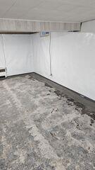 CleanSpace® vapor barrier lines the basement walls, directing moisture to the newly installed WaterGuard® drainage system along the floor perimeter.