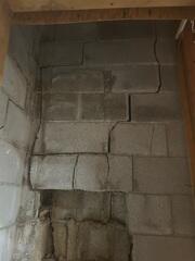 Wet clay soils can expand enough to put literally thousands of pounds of pressure on a foundation wall. This can force the walls inwards, sometimes causing them to buckle and crack. Look also for walls pushing in at the bottom or tilting in at the top.