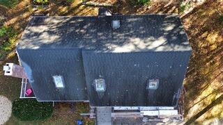 This drone shot shows the original roof before any work began. The shingles were worn, several were slipping out of place, and moss had built up across multiple sections. From above, you can really see how uneven the surface had become after more than 15 years of weather exposure.