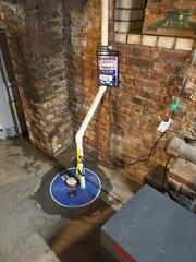 SuperSump was installed in the corner to pump water out of the basement. Each sump pump has an alarm to alert the homeowner if the water levels get too high or if there's a problem with the system.