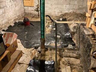 The crawl space exhibited significant moisture problems and uneven ground conditions, rendering it unsuitable for use. Items stored in the area were at risk of damage, as the previously installed tarp provided little to no protection against moisture intrusion.
