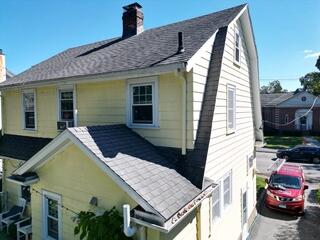 The original roof before work began, showing signs of age and wear that made a full roof replacement the best option for long-term protection.