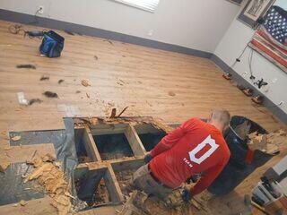 To begin the repair process, the LRE team removed the damaged subfloor, allowing access to repair the floor joists and replace the deteriorated wood.