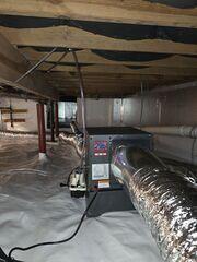 Encapsulated crawl space featuring a professionally installed dehumidifier to help control humidity and reduce moisture buildup.