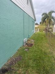 This side of the home experienced severe, recurring flooding, with rainwater pooling along the foundation during heavy storms.